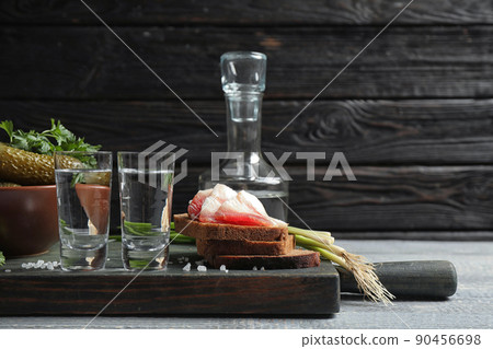 Cold Russian vodka with snacks on wooden table Cold Russian vodka with snacks on wooden table 90456698