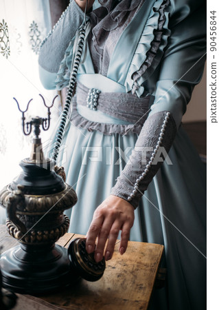 Woman in blue vintage dress 1800s early 1900s clothing. Edwardian Victorian Epoque dress 90456844