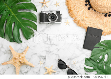 Flat lay composition with professional photographer camera, passport and space for text on white marble table Flat lay composition with professional photographer camera, passport and space for text on white marble table 90456912
