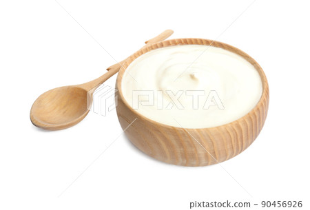 Tasty organic yogurt in wooden bowl and spoon isolated on white 90456926