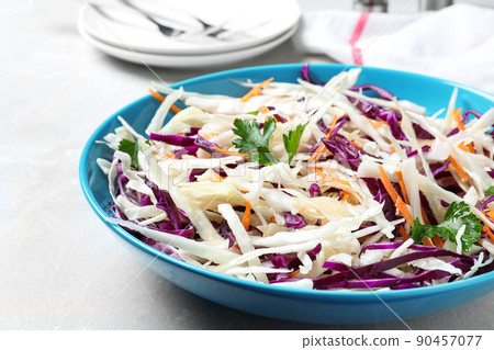 Tasty salad with cabbage on light grey marble table, closeup 90457077