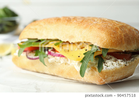 Delicious sandwich with fresh vegetables and cheese on white table, closeup 90457518