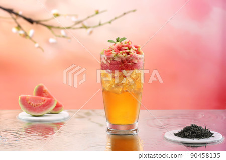 Woman's hand is pouring water from butterfly pea flower into a glass of lemon and honey tea. Butterfly pea or blue pea, Asia herb drink with lemon and honey.  90458135