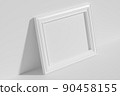 Horizontal rectangular photo frame on floor leaning at wall top diagonal view 90458155