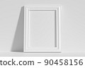 Vertical rectangular photo frame on floor leaning at wall 90458156