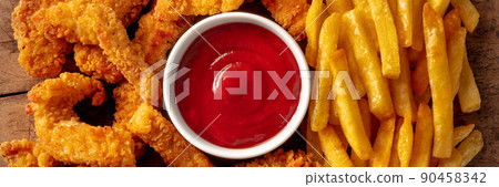Chicken tenders panorama, crispy meat nuggets with a bbq dip and potato Chicken tenders panorama, crispy meat nuggets with a bbq dip and potato 90458342