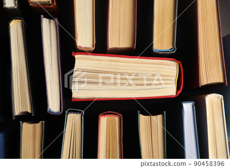 Many different hardcover books on dark background, top view 90458396