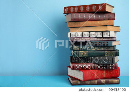 Stack of hardcover books on light blue background, space for text Stack of hardcover books on light blue background, space for text 90458400