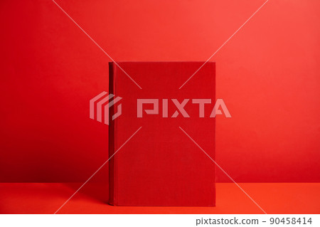 Hardcover book on red background. Space for design 90458414