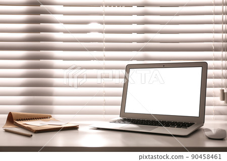 Laptop on desk near window in office. Comfortable workplace Laptop on desk near window in office. Comfortable workplace 90458461