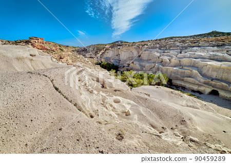 Famous white rocks of Sarakiniko beach, Aegean sea, Milos island , Greece. No people, empty cliffs, summer sunshine, blue sky and clouds 90459289