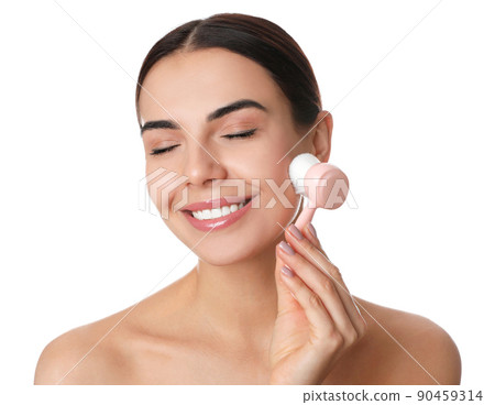 Young woman using facial cleansing brush on white background. Washing accessory 90459314