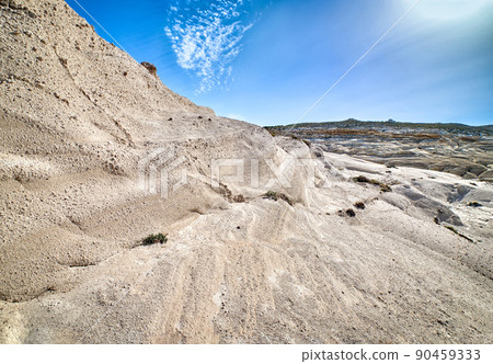 Famous white rocks of Sarakiniko beach, Aegean sea, Milos island, Greece. No people, empty cliffs, summer sunshine, clear blue sky and clouds 90459333