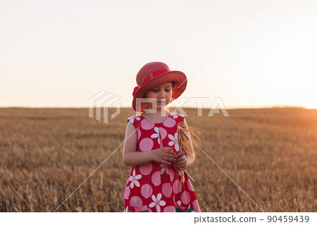 Child girl in straw hat dress in wheat field. Smiling kid in sunglasses sunset countryside. Cottagecore style aesthetic. Child girl in straw hat dress in wheat field. Smiling kid in sunglasses sunset countryside. Cottagecore style aesthetic. 90459439