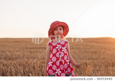 Child girl in straw hat dress in wheat field. Smiling kid in sunglasses sunset countryside. Cottagecore style aesthetic. Child girl in straw hat dress in wheat field. Smiling kid in sunglasses sunset countryside. Cottagecore style aesthetic. 90459440
