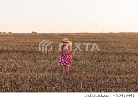 Child girl in straw hat dress in wheat field. Smiling kid in sunglasses sunset countryside. Cottagecore style aesthetic. Child girl in straw hat dress in wheat field. Smiling kid in sunglasses sunset countryside. Cottagecore style aesthetic. 90459441
