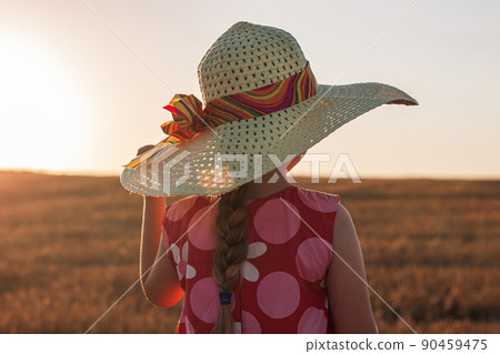 Child girl in straw hat dress in wheat field. Smiling kid in sunglasses sunset countryside. Cottagecore style aesthetic. Child girl in straw hat dress in wheat field. Smiling kid in sunglasses sunset countryside. Cottagecore style aesthetic. 90459475