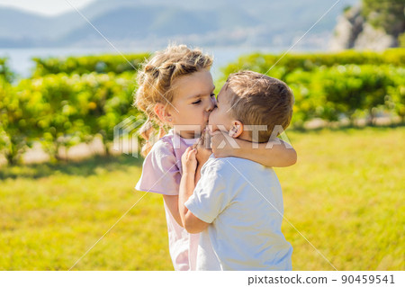 Portrait of two cute adorable baby children toddlers hugging and kissing each other, love friendship in childhood concept, best friends forever 90459541