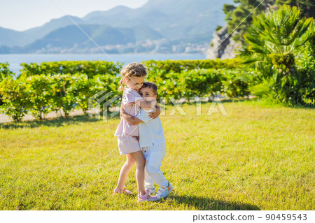 Portrait of two cute adorable baby children toddlers hugging and kissing each other, love friendship in childhood concept, best friends forever 90459543