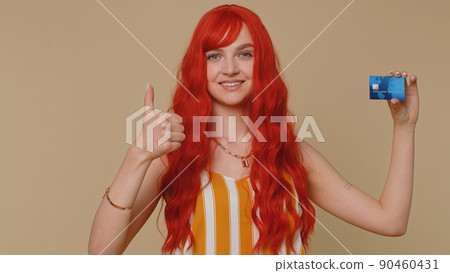 Redhead woman show plastic credit bank card advertising transferring money cashless online shopping 90460431