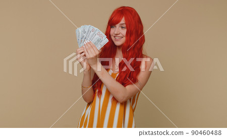 Redhead girl holding cash money dollar celebrate dance, success business career, lottery game winner 90460488
