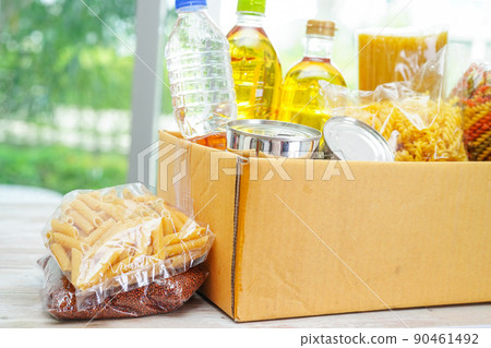 Foodstuffs in donation box for volunteer. 90461492