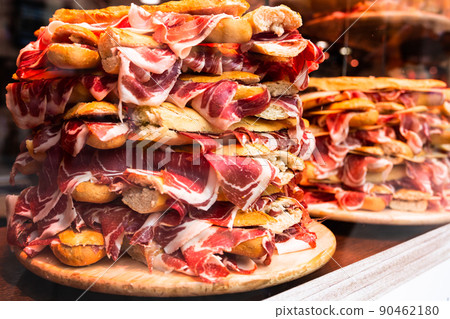 mouth watering sandwiches with jamon laid out in a slide on shop window 90462180