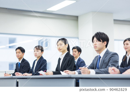 Men and women in suits taking seminars Men and women in suits taking seminars 90462829