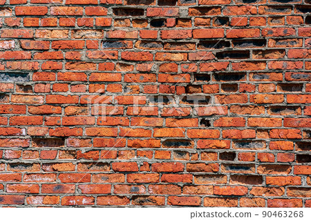 background, texture of a heavily weathered old red brick wall 90463268