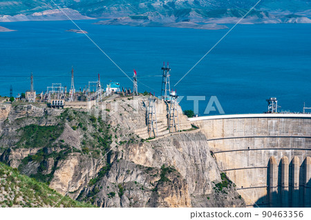 upper part of huge arch dam of the hydroelectric power station and the electrical substation in a high mountain canyon, the Chirkeyskaya HPP in Dagestan 90463356
