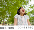 Cute little girl is laughing in the garden 90463769