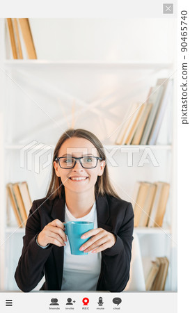 Online courses. Happy woman. Screen mockup. Smiling smart lady sitting work desk with cup of coffee having webinar in light room interior. 90465740