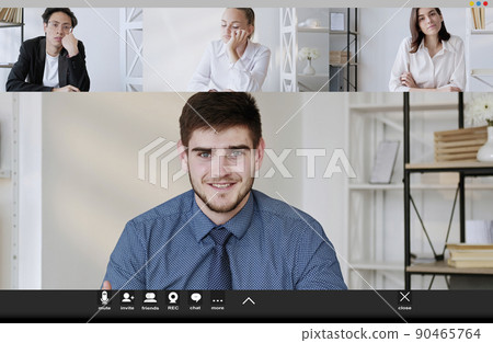 Virtual training. Online meeting. Screen mockup. Happy male coach having online conference with two women and boring man in light room interior. 90465764