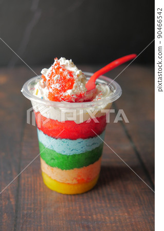 rainbow color cake in a plastic container on table rainbow color cake in a plastic container on table 90466542