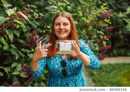 Female hands with white box at city park background.Box closeup. Blank packing, empty space. People communication. Carton case. High quality photo Female hands with white box at city park background.Box closeup. Blank packing, empty space. People communication. Carton case. High quality photo 90466546