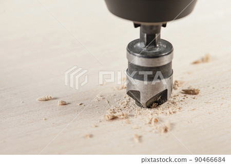 Countersink for deepening the self-tapping screw. A countersink drill makes a recess in a hole for a screw in a wooden board. Countersink for deepening the self-tapping screw. A countersink drill makes a recess in a hole for a screw in a wooden board. 90466684