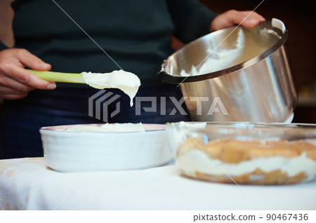 Close-up. Female chef pastry preparing cheese cream for cake at home. Culinary, homemade dessert Close-up. Female chef pastry preparing cheese cream for cake at home. Culinary, homemade dessert 90467436