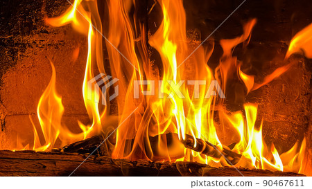 Flames of fire on a black background. Burning wood in the fireplace 90467611