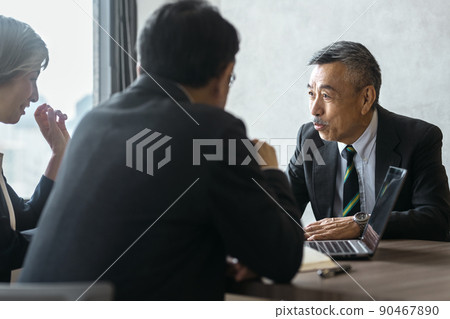 Senior business team in suits meeting in the office 90467890