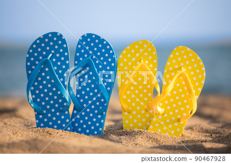 Beach flip-flops on the sand 90467928