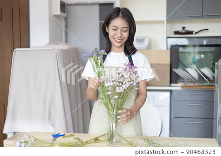 Bouquet, Asian woman puts a beautiful bouquet of colorful flowers in a vase to decorate the room, Freshen up and decorate the room, Decorations and arrangements, Flowers bunch, Arts and crafts. 90468323