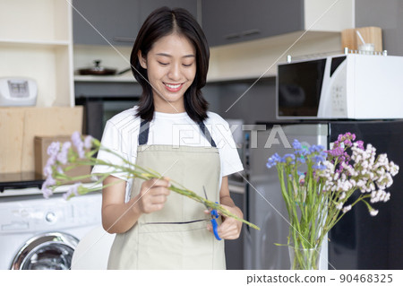 Bouquet, Asian woman puts a beautiful bouquet of colorful flowers in a vase to decorate the room, Freshen up and decorate the room, Decorations and arrangements, Flowers bunch, Arts and crafts. Bouquet, Asian woman puts a beautiful bouquet of colorful flowers in a vase to decorate the room, Freshen up and decorate the room, Decorations and arrangements, Flowers bunch, Arts and crafts. 90468325