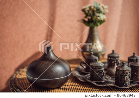 Aroma oil diffuser with aroma oil on table at home. Air freshener Aroma oil diffuser with aroma oil on table at home. Air freshener 90468942