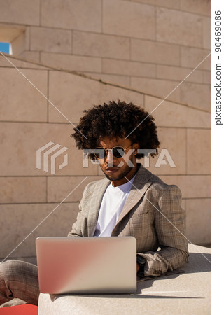 Focused African American man working in open air Focused African American man working in open air 90469086