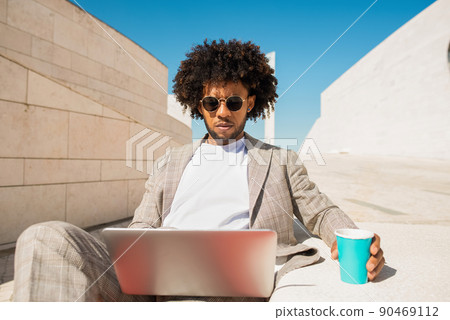 Stylish African American man working in open air 90469112