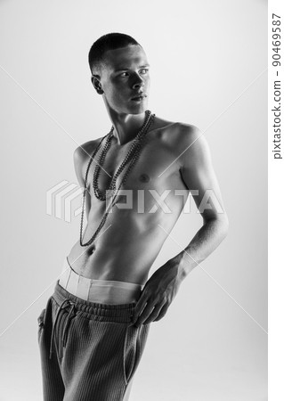 Portrait of handsome young man posing shirtless. Black and white photography. Male accessories. Portrait of handsome young man posing shirtless. Black and white photography. Male accessories. 90469587