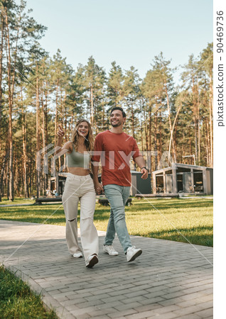 Romantic couple enjoying their stroll in the recreation area Romantic couple enjoying their stroll in the recreation area 90469736