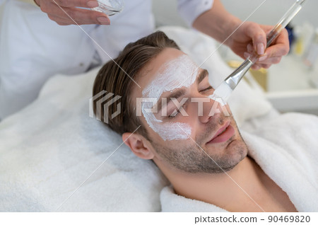Close up of a man with a moisturizing mask on his face 90469820