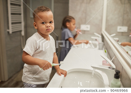 Little Boy Brushing Teeth in Bathroom Little Boy Brushing Teeth in Bathroom 90469966