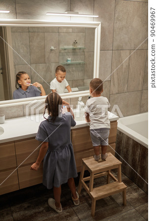 Two Kids Brushing Teeth in Bathroom Two Kids Brushing Teeth in Bathroom 90469967